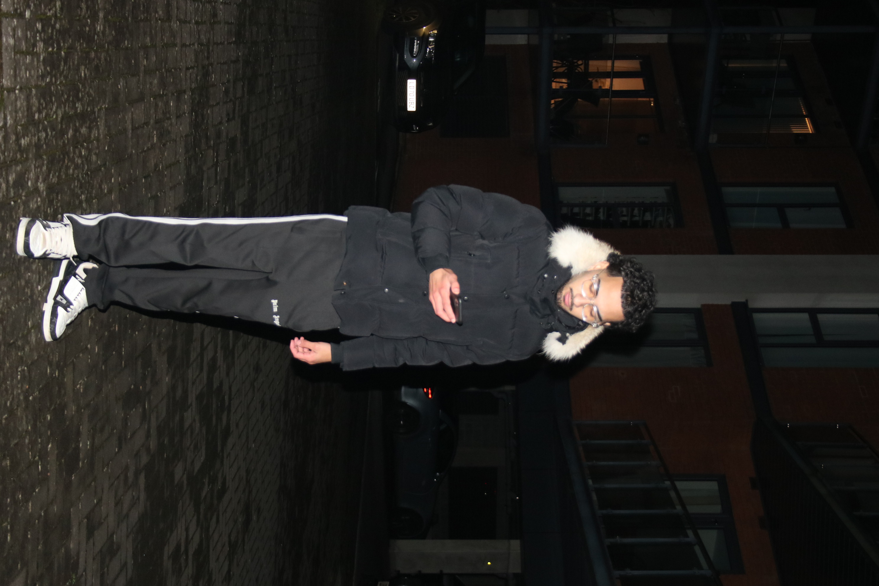 Birthday portrait with direct evening flash against moody cityscape