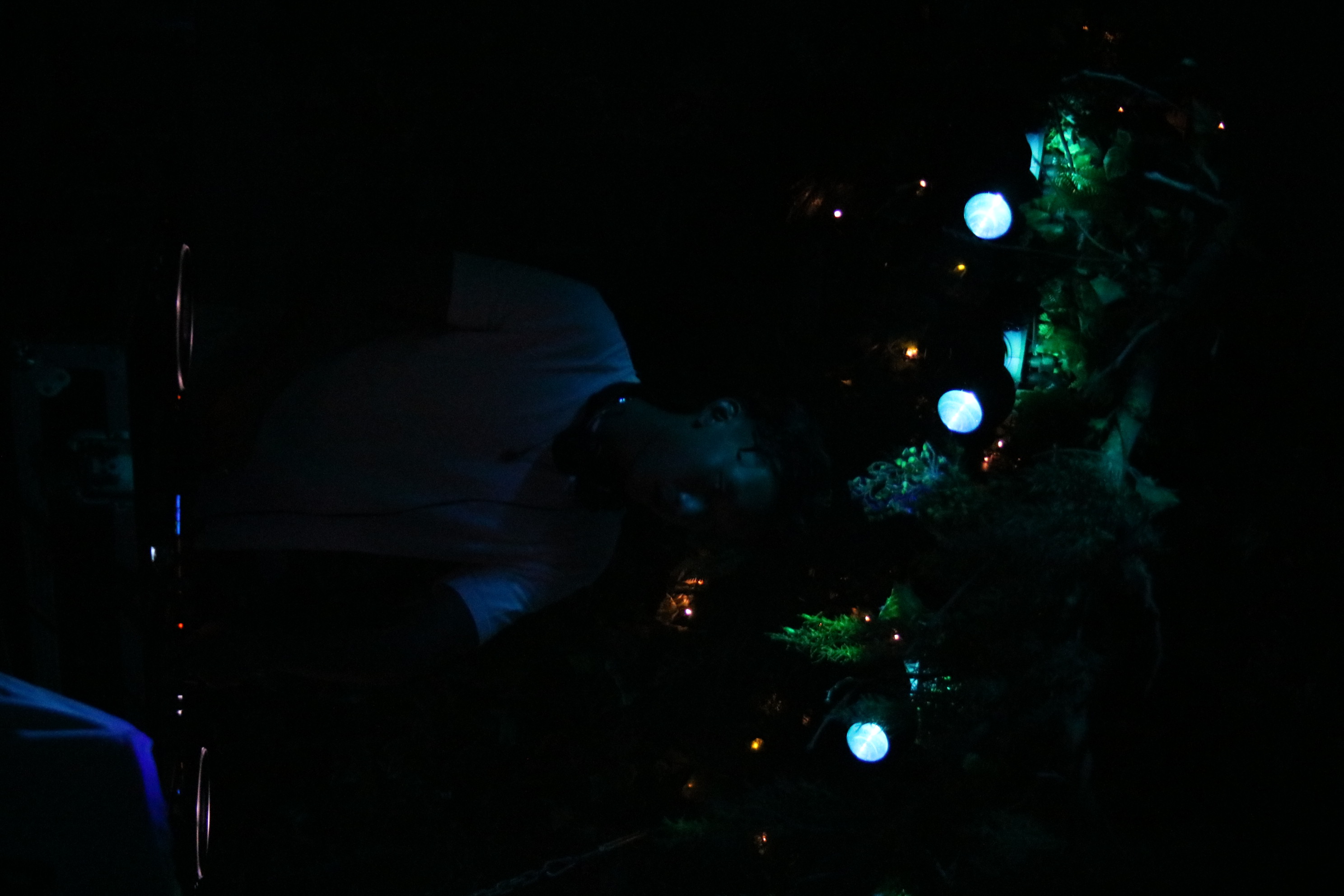 Atmospheric DJ silhouette under cyan wash